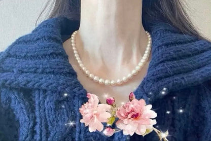 Tsutsumi Aurora Akoya pearl necklace and matching earrings with 8mm round pink-green pearls and silver clasps