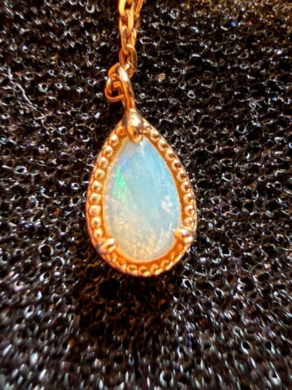 agete K10 gold necklace featuring a glowing opal pendant on a delicate chain