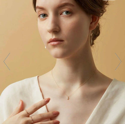 agete K10 gold necklace featuring a glowing opal pendant on a delicate chain