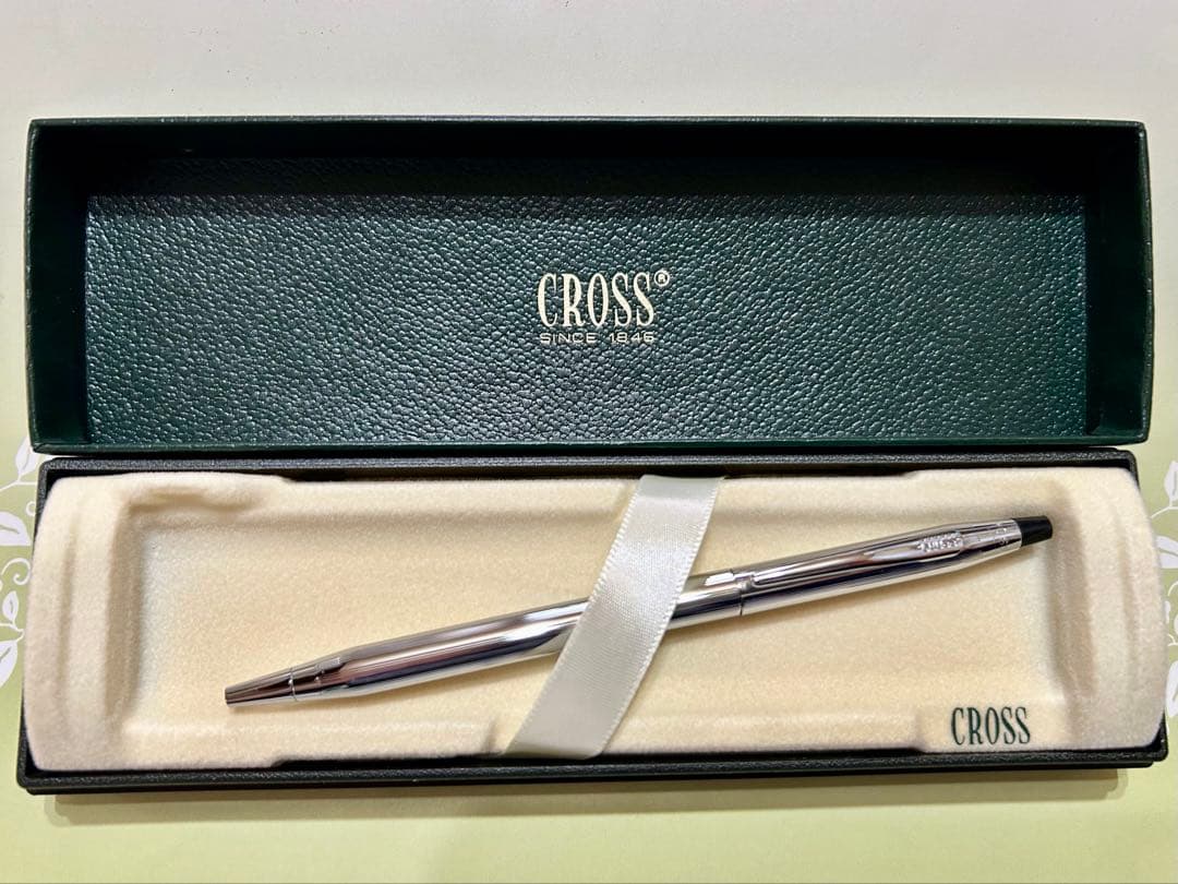 New unused CROSS ballpoint pen in original box with sleek black barrel and silver clip