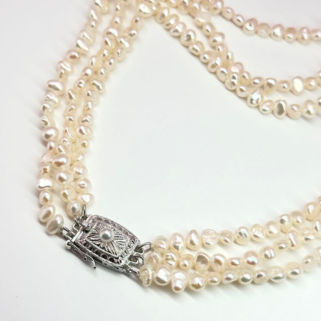 Tasaki Baroque Pearl three-strand necklace about 80cm long displayed on a white background