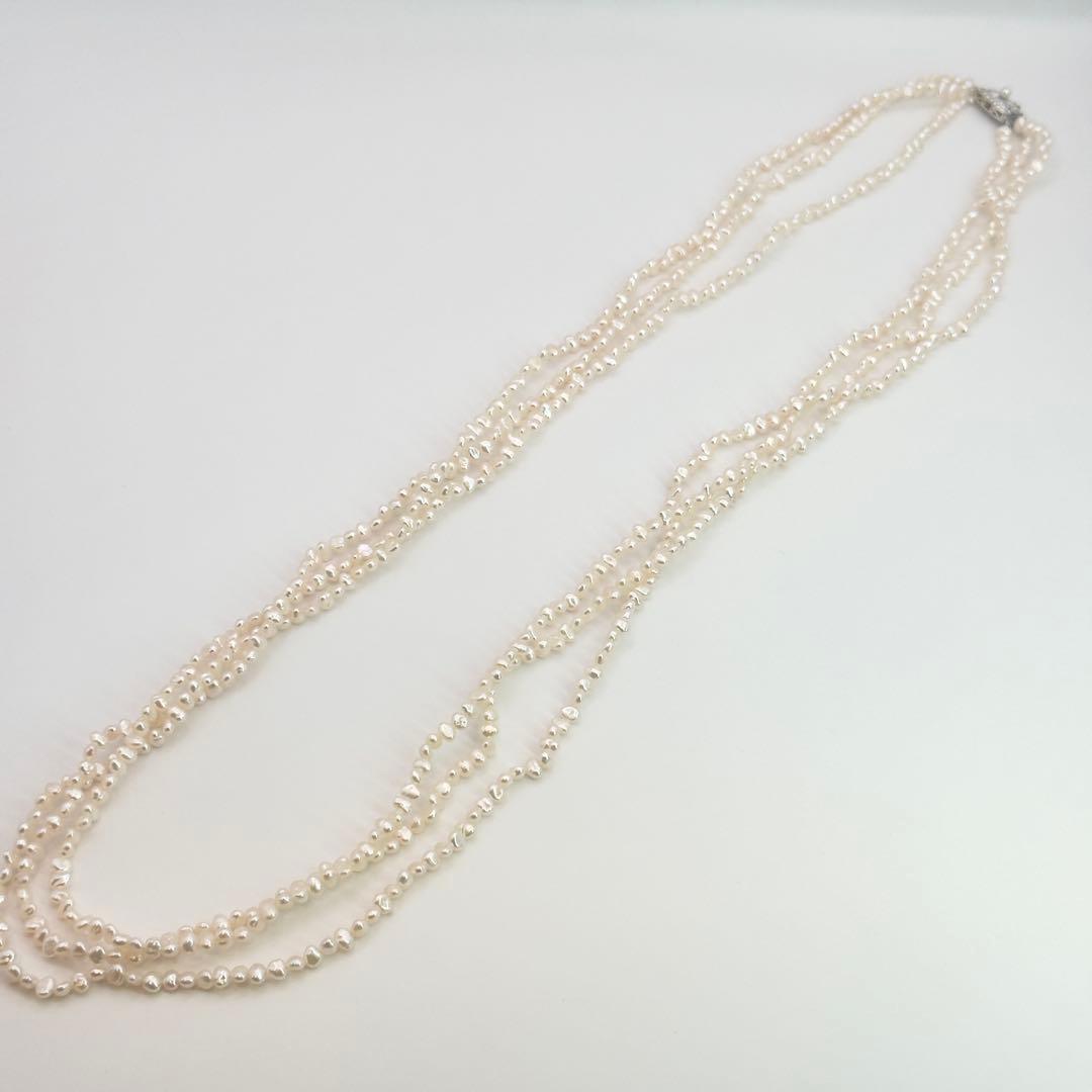 Tasaki Baroque Pearl three-strand necklace about 80cm long displayed on a white background