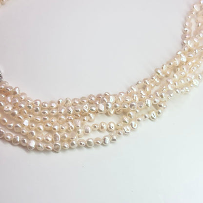 Tasaki Baroque Pearl three-strand necklace about 80cm long displayed on a white background