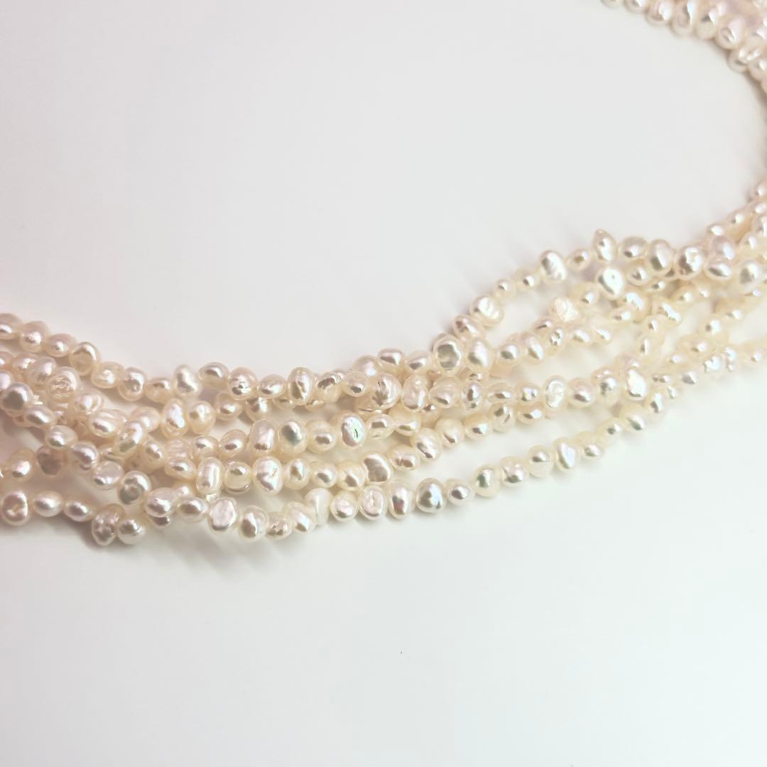 Tasaki Baroque Pearl three-strand necklace about 80cm long displayed on a white background