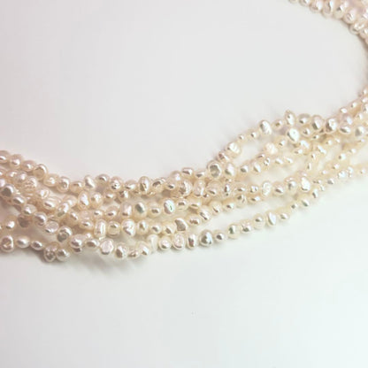 Tasaki Baroque Pearl three-strand necklace about 80cm long displayed on a white background