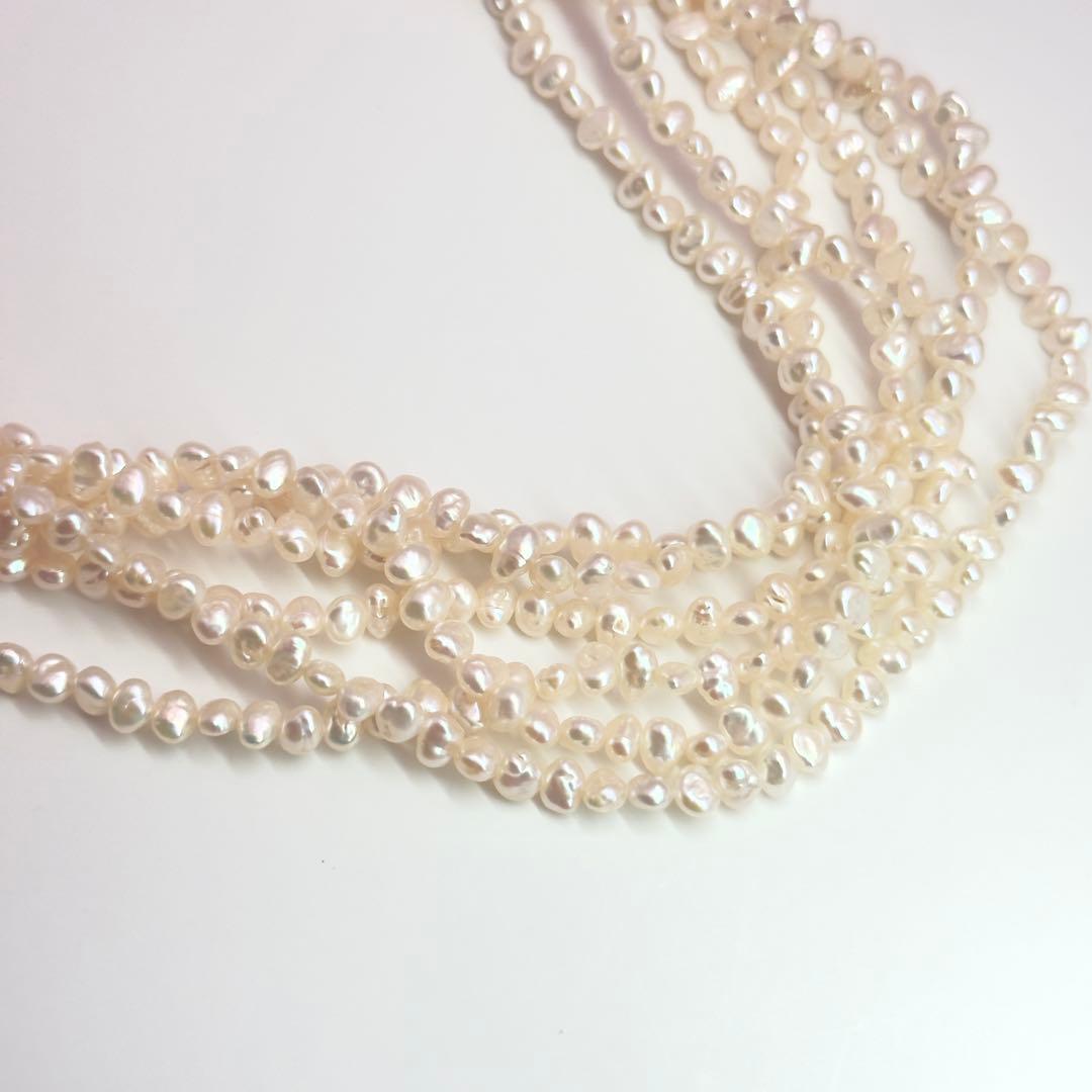 Tasaki Baroque Pearl three-strand necklace about 80cm long displayed on a white background