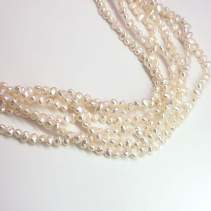 Tasaki Baroque Pearl three-strand necklace about 80cm long displayed on a white background