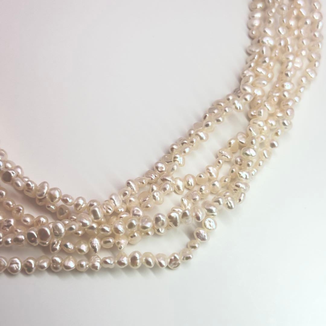 Tasaki Baroque Pearl three-strand necklace about 80cm long displayed on a white background
