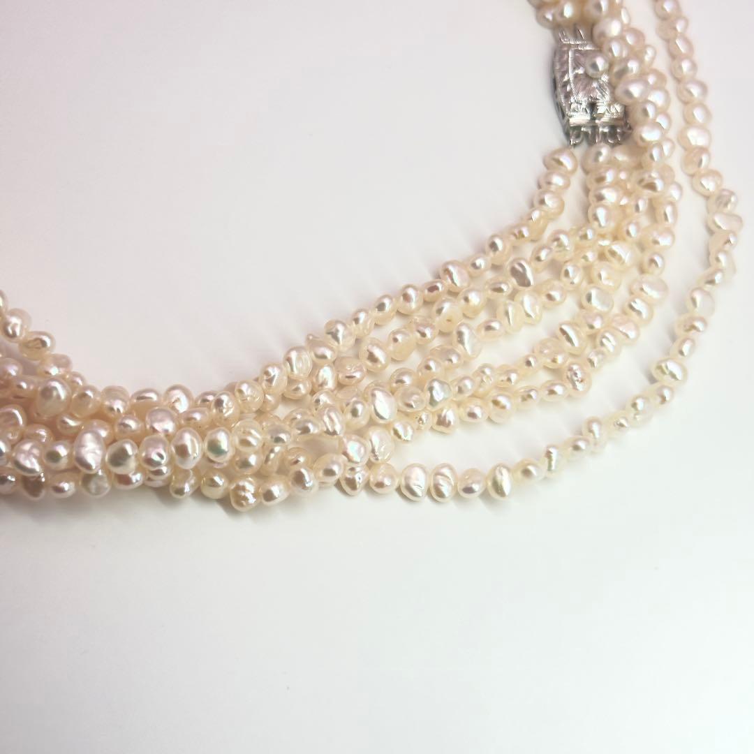 Tasaki Baroque Pearl three-strand necklace about 80cm long displayed on a white background