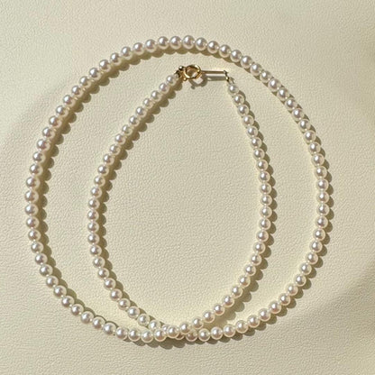 K18 Akoya baby pearl necklace with 3.0-3.5mm pearls and 42 cm length on white background