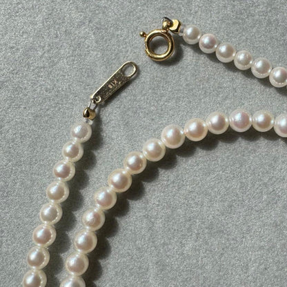 K18 Akoya baby pearl necklace with 3.0-3.5mm pearls and 42 cm length on white background