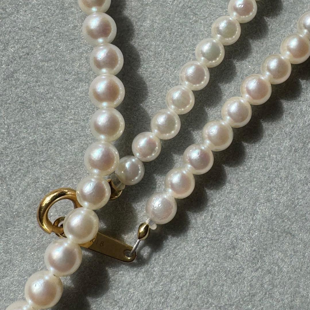 K18 Akoya baby pearl necklace with 3.0-3.5mm pearls and 42 cm length on white background