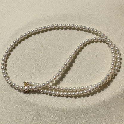 K18 Akoya baby pearl necklace with 3.0-3.5mm pearls and 42 cm length on white background