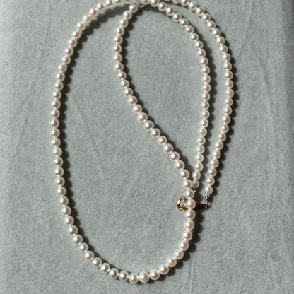 K18 Akoya baby pearl necklace with 3.0-3.5mm pearls and 42 cm length on white background