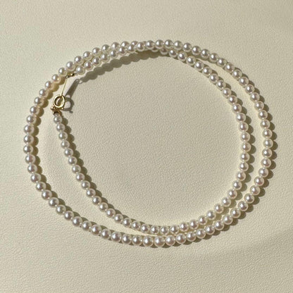 K18 Akoya baby pearl necklace with 3.0-3.5mm pearls and 42 cm length on white background