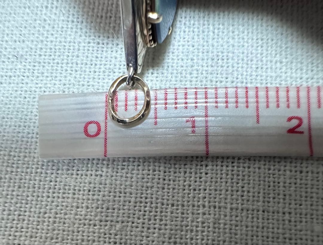 Agete charm made of K10 silver featuring opal and 0.008ct diamond measuring 1.25 by 2.3 cm