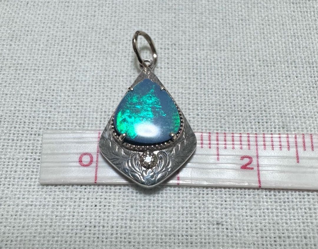 Agete charm made of K10 silver featuring opal and 0.008ct diamond measuring 1.25 by 2.3 cm