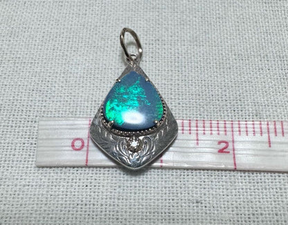 Agete charm made of K10 silver featuring opal and 0.008ct diamond measuring 1.25 by 2.3 cm