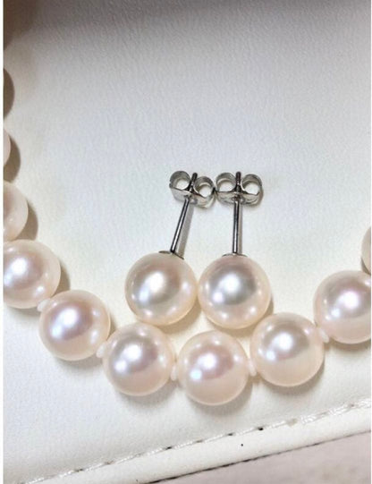 Akoya pearl necklace with 7.5-8mm pearls and matching 8mm silver earrings on white background