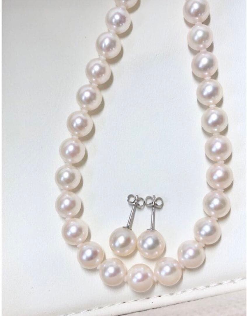 Akoya pearl necklace with 7.5-8mm pearls and matching 8mm silver earrings on white background