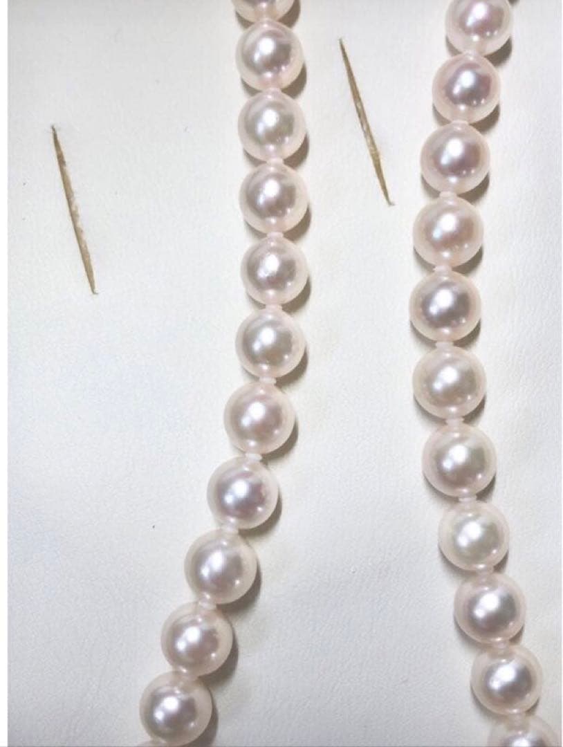 Akoya pearl necklace with 7.5-8mm pearls and matching 8mm silver earrings on white background