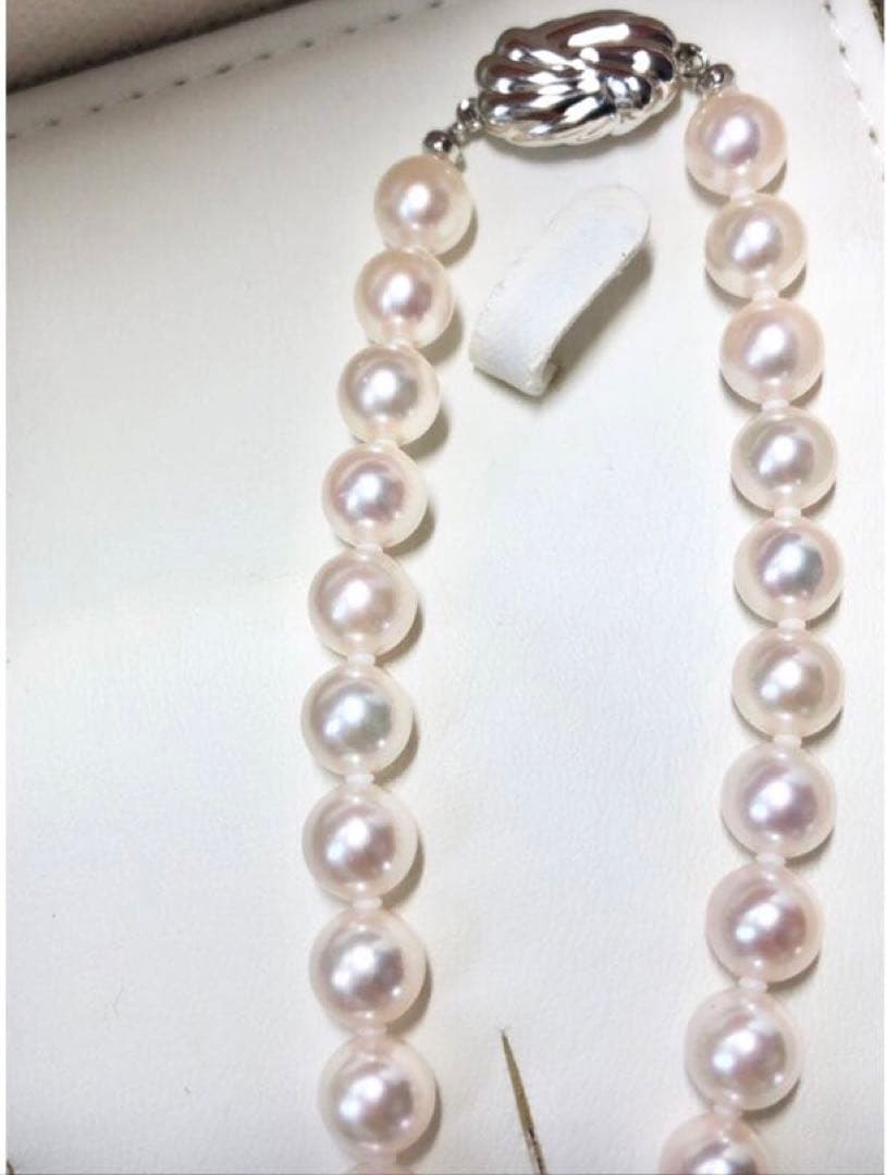 Akoya pearl necklace with 7.5-8mm pearls and matching 8mm silver earrings on white background