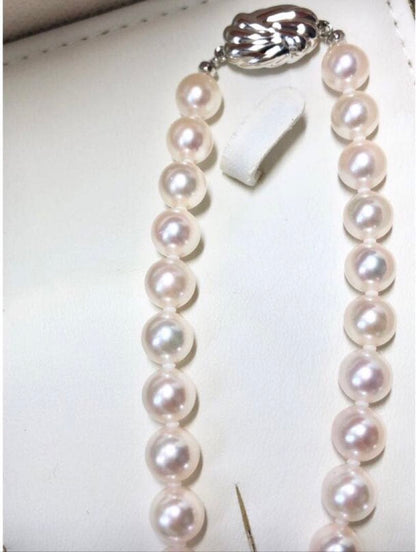 Akoya pearl necklace with 7.5-8mm pearls and matching 8mm silver earrings on white background