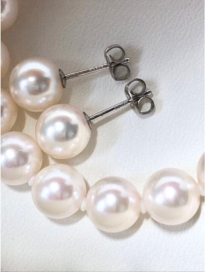 Akoya pearl necklace with 7.5-8mm pearls and matching 8mm silver earrings on white background