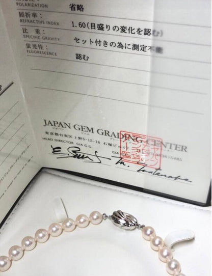 Akoya pearl necklace with 7.5-8mm pearls and matching 8mm silver earrings on white background