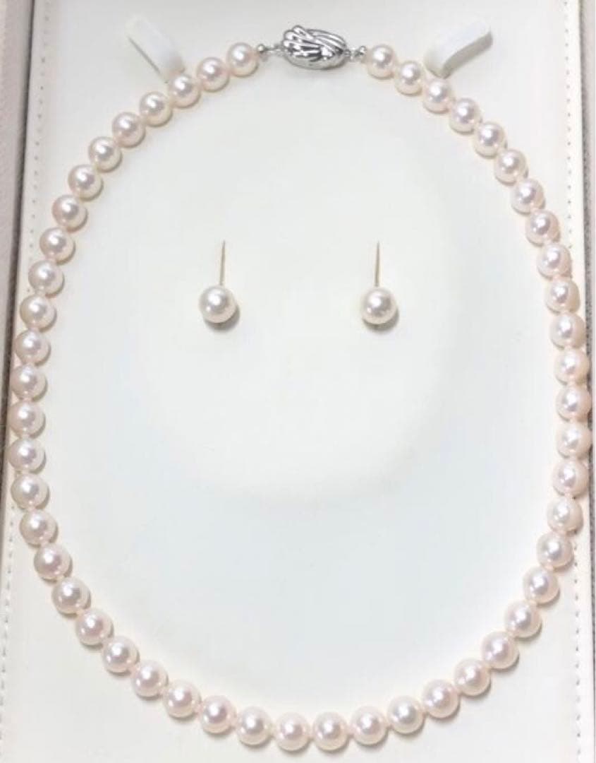 Akoya pearl necklace with 7.5-8mm pearls and matching 8mm silver earrings on white background