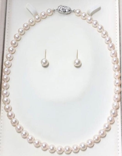Akoya pearl necklace with 7.5-8mm pearls and matching 8mm silver earrings on white background