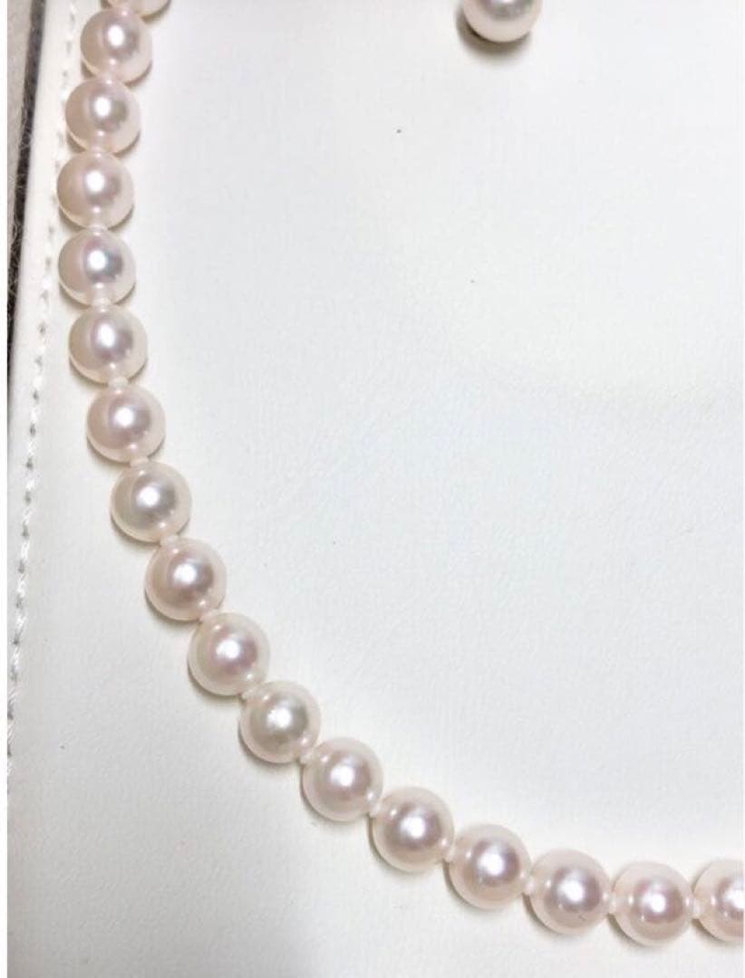 Akoya pearl necklace with 7.5-8mm pearls and matching 8mm silver earrings on white background