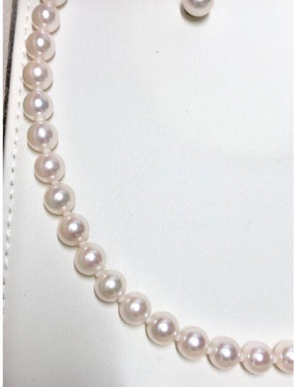 Akoya pearl necklace with 7.5-8mm pearls and matching 8mm silver earrings on white background