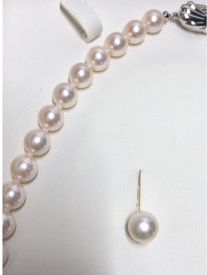 Akoya pearl necklace with 7.5-8mm pearls and matching 8mm silver earrings on white background