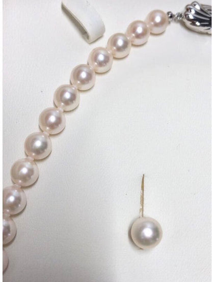 Akoya pearl necklace with 7.5-8mm pearls and matching 8mm silver earrings on white background