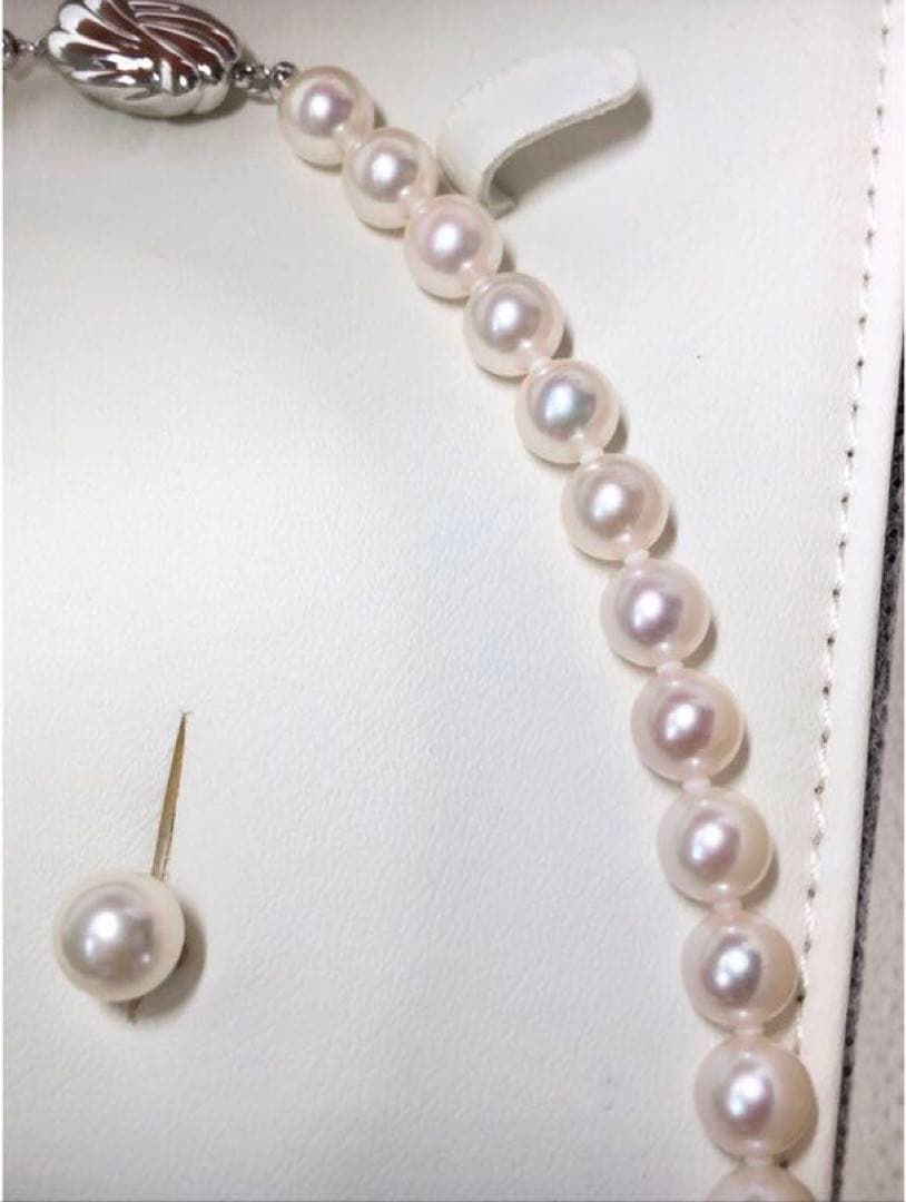 Akoya pearl necklace with 7.5-8mm pearls and matching 8mm silver earrings on white background
