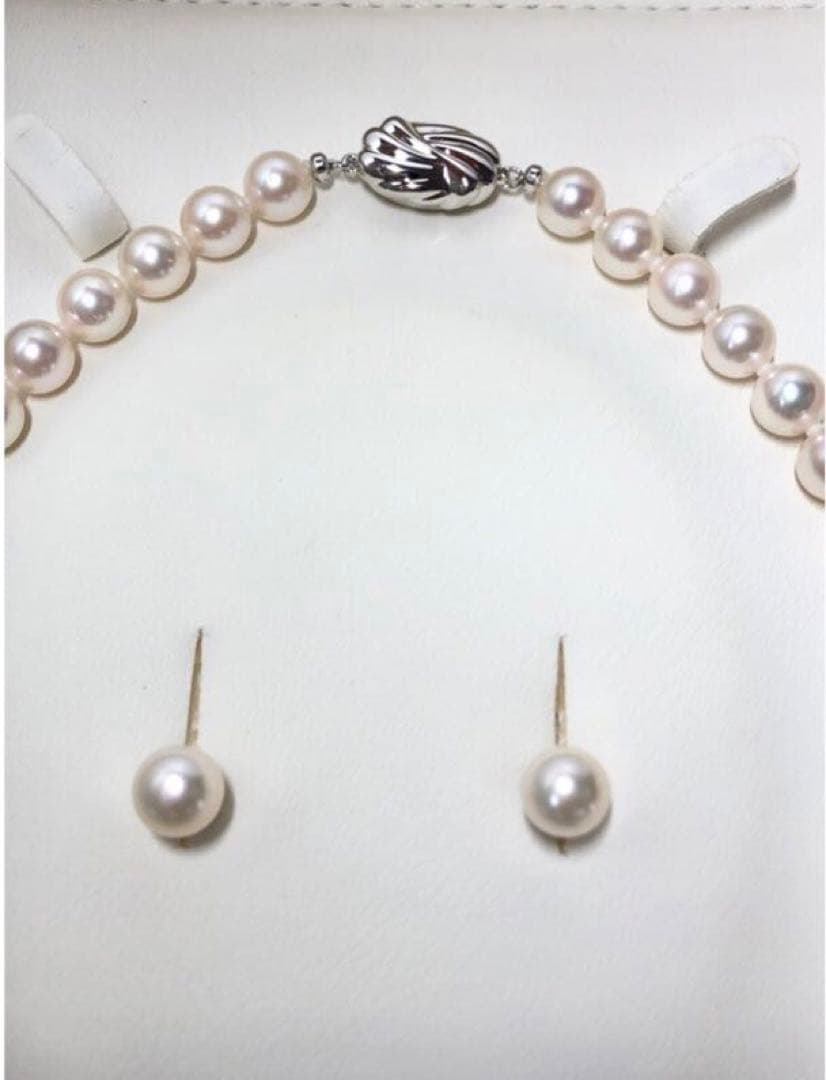 Akoya pearl necklace with 7.5-8mm pearls and matching 8mm silver earrings on white background