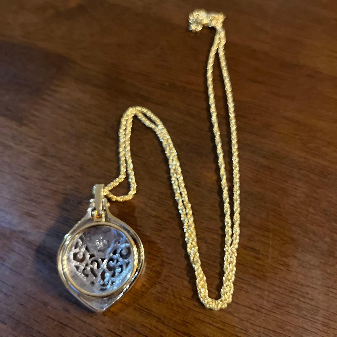 Mikimoto Loupe Pendant Pearl Necklace with a single white pearl and gold chain shown on a white background
