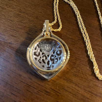 Mikimoto Loupe Pendant Pearl Necklace with a single white pearl and gold chain shown on a white background