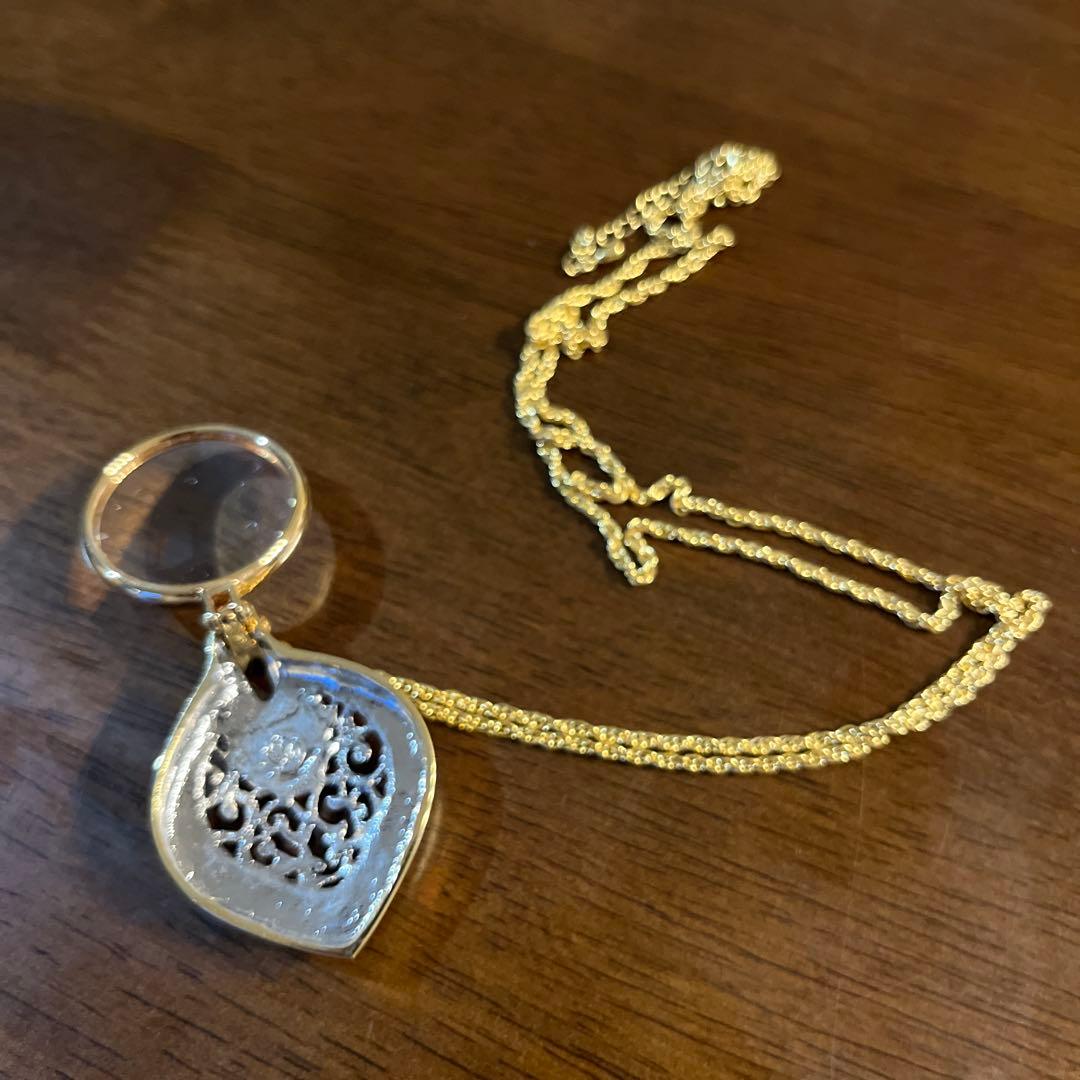 Mikimoto Loupe Pendant Pearl Necklace with a single white pearl and gold chain shown on a white background