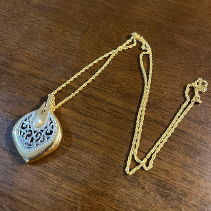 Mikimoto Loupe Pendant Pearl Necklace with a single white pearl and gold chain shown on a white background