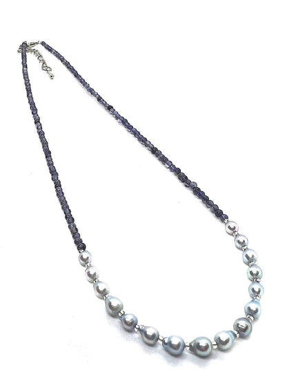 Akoya pearl necklace featuring natural blue baby pearls and small iolite stones on a 41 to 46 cm chain