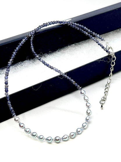 Akoya pearl necklace featuring natural blue baby pearls and small iolite stones on a 41 to 46 cm chain