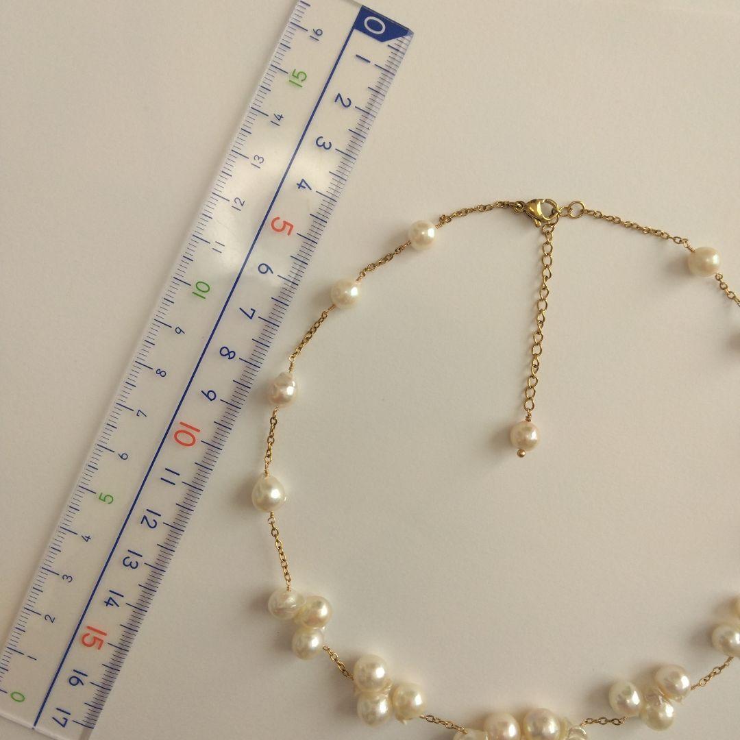 Akoya pearl necklace with flower-shaped pearls in gold color on stainless steel chain