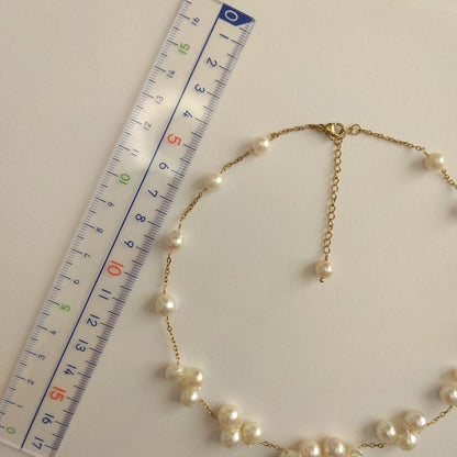 Akoya pearl necklace with flower-shaped pearls in gold color on stainless steel chain