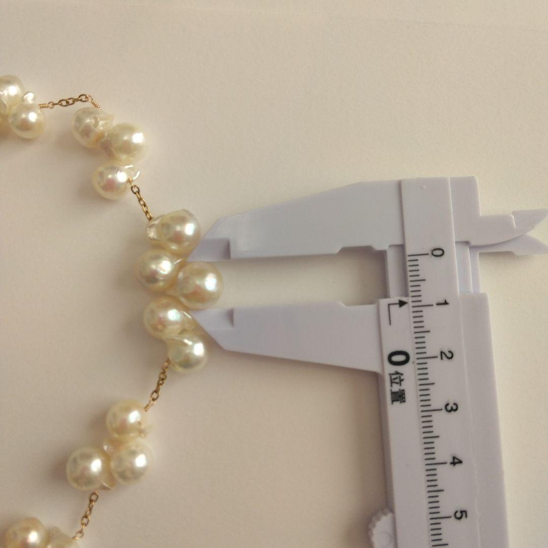 Akoya pearl necklace with flower-shaped pearls in gold color on stainless steel chain