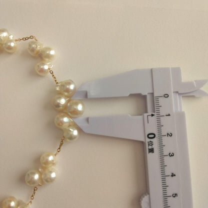 Akoya pearl necklace with flower-shaped pearls in gold color on stainless steel chain