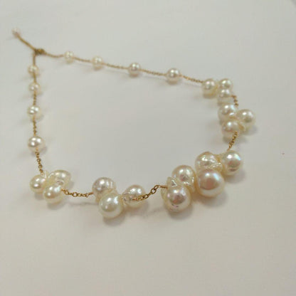 Akoya pearl necklace with flower-shaped pearls in gold color on stainless steel chain
