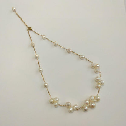 Akoya pearl necklace with flower-shaped pearls in gold color on stainless steel chain