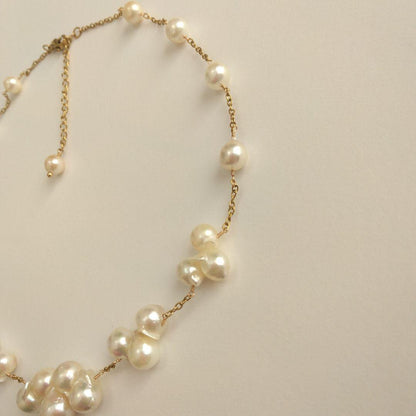 Akoya pearl necklace with flower-shaped pearls in gold color on stainless steel chain